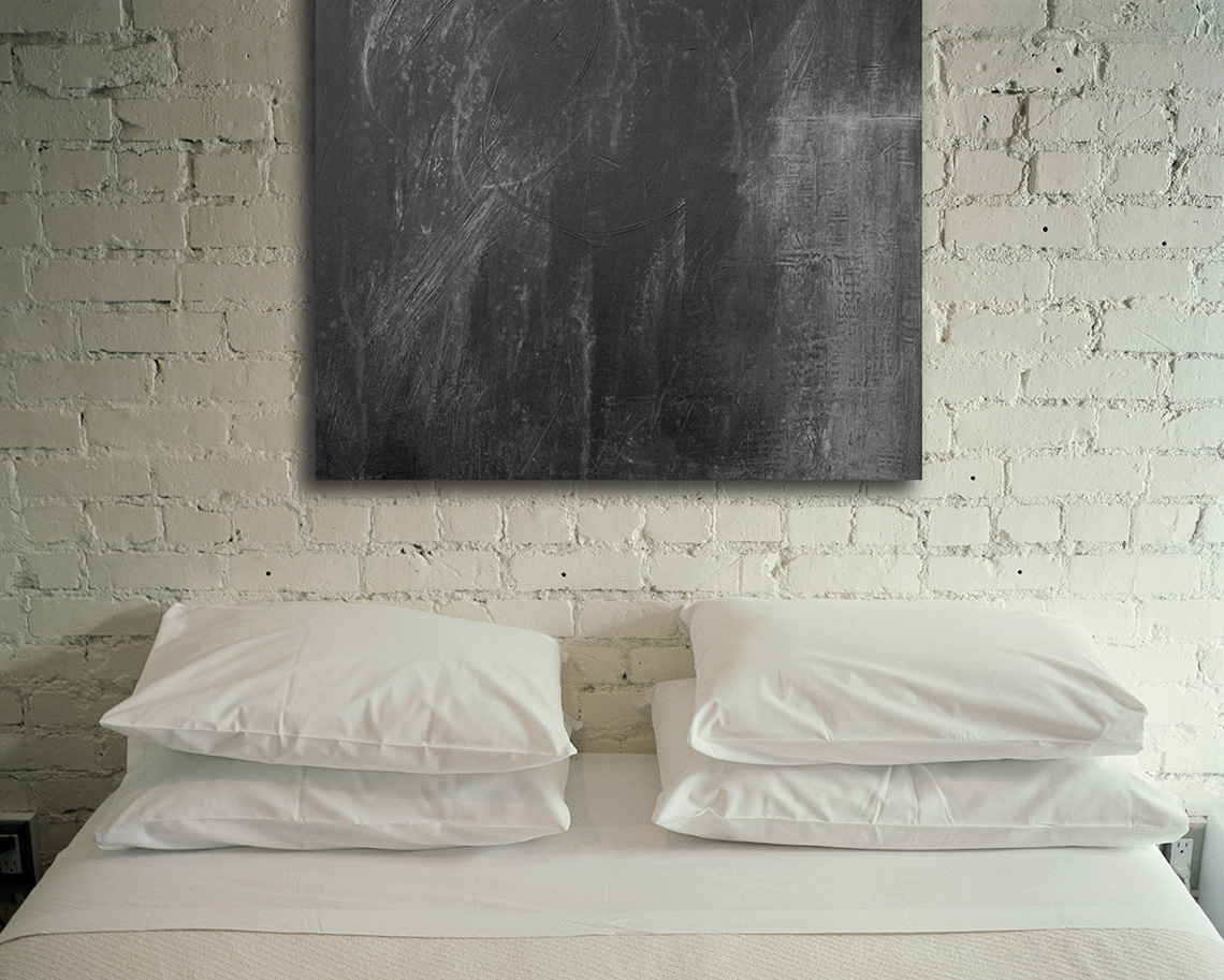 Contemporary Abstract painting that is black and white hanging above bed